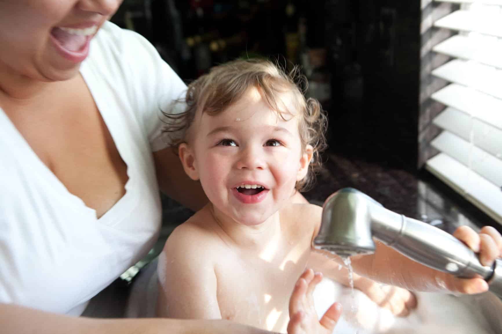 Mother Bathing Her Son In The Sink.