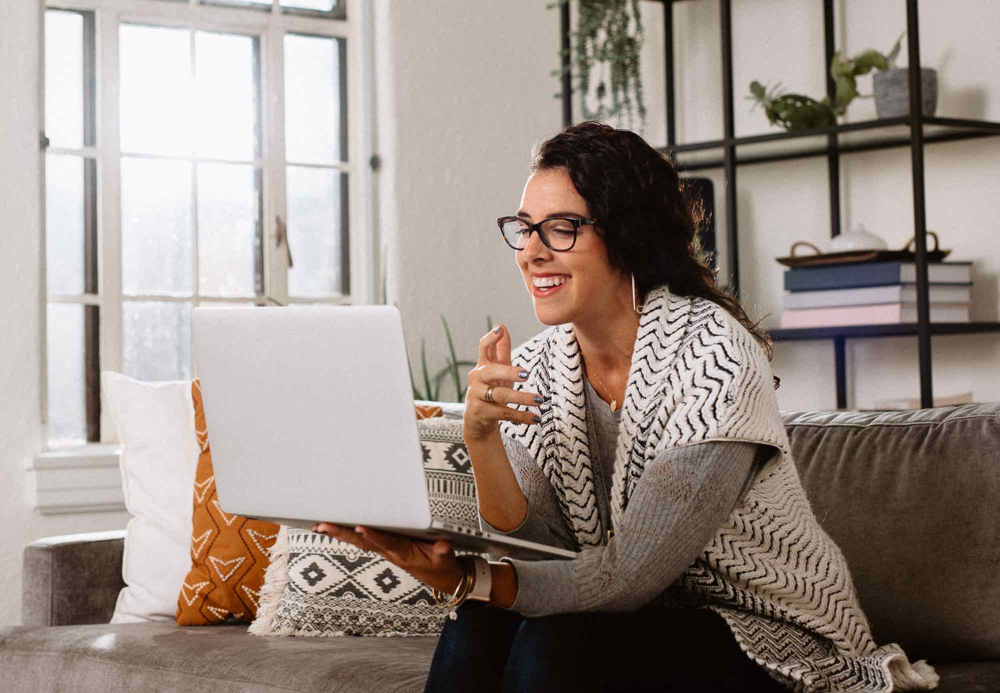 Woman interacting with a Lyra coach via video on her laptop.