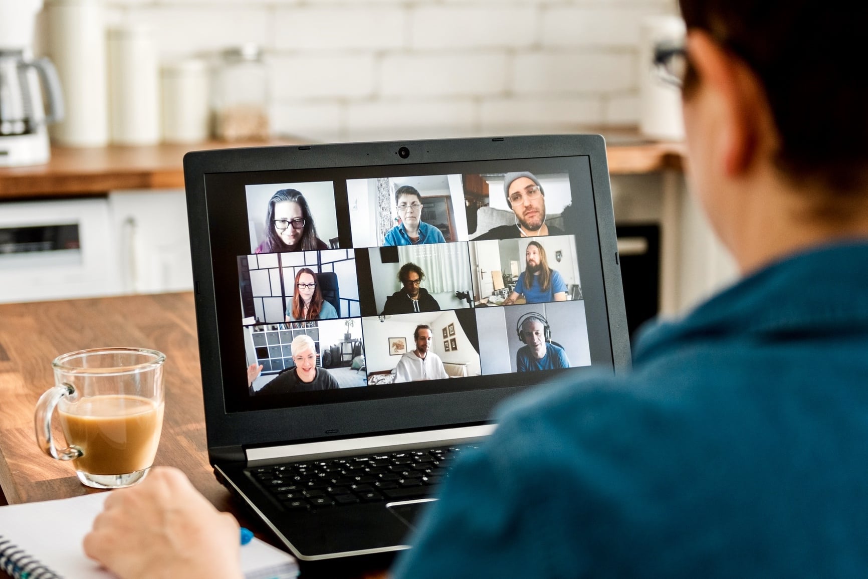 Anonymous woman having a video call with team members