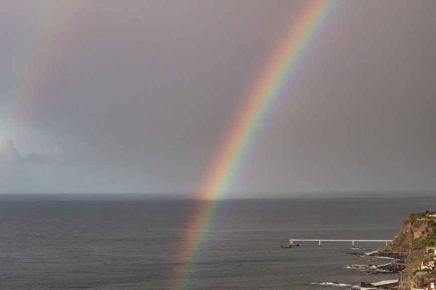 Receding storm clouds and a rainbow over the Atlantic Ocean