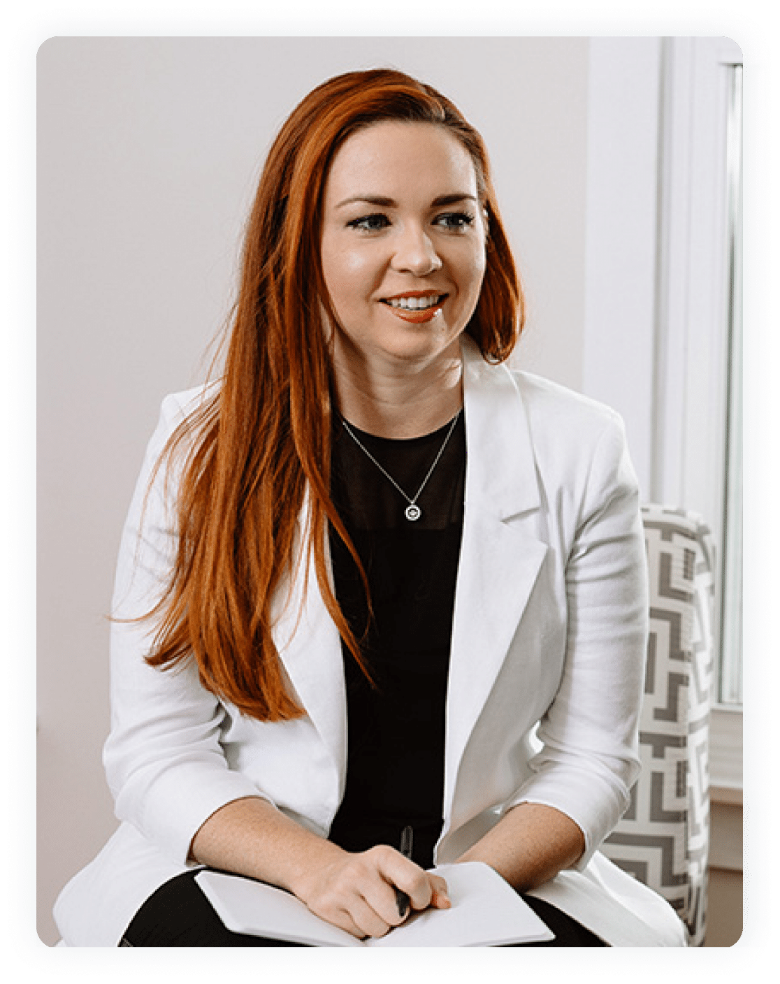 Caucasian woman wearing white lab coat and holding paperwork