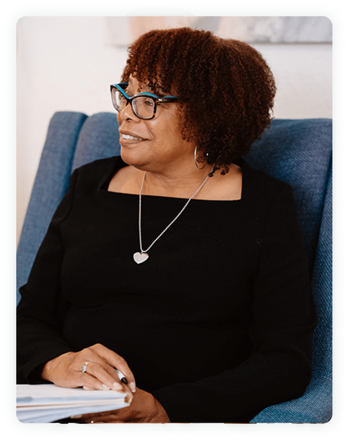 African American professional woman smiling and holding notebook