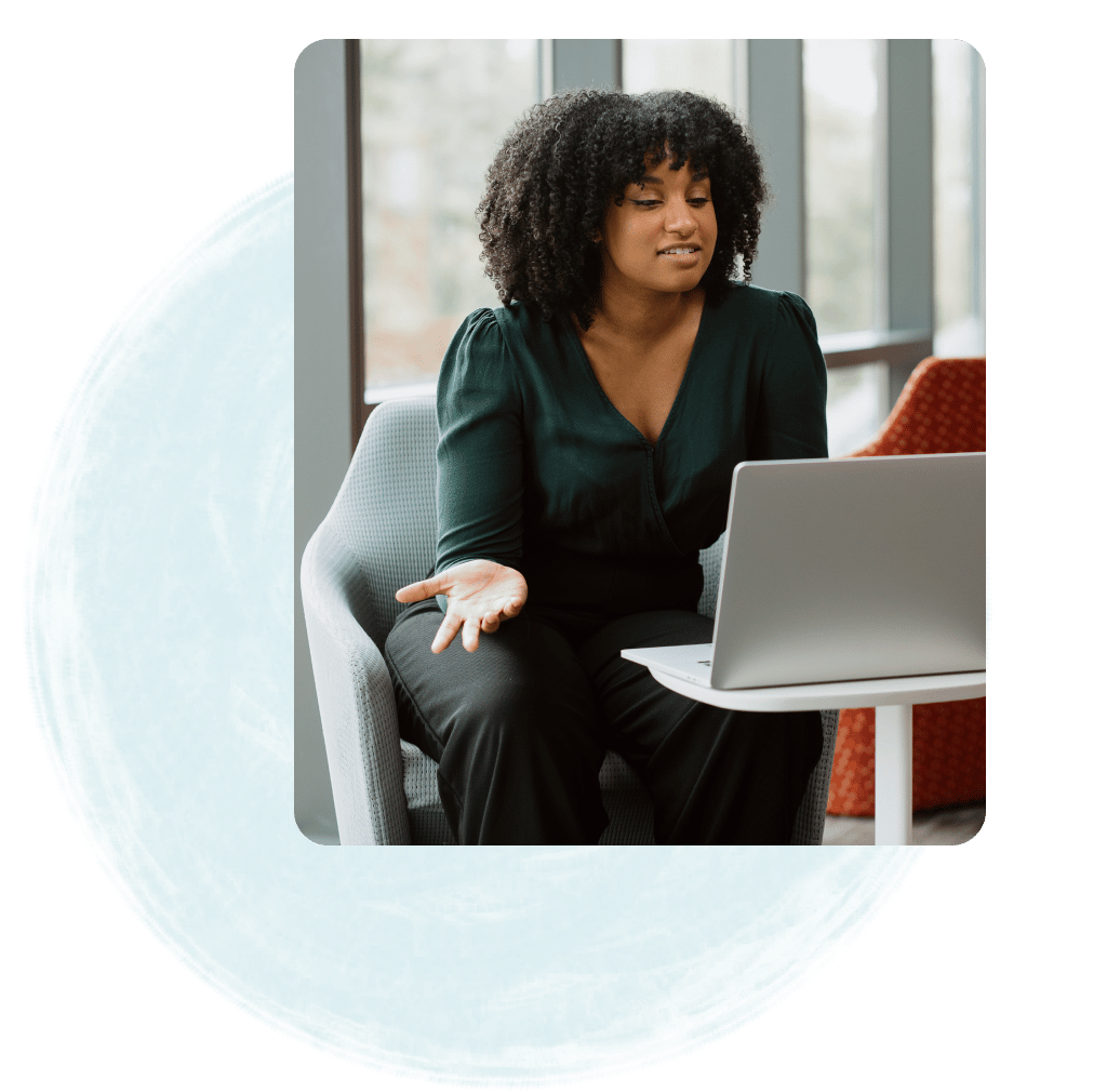 Woman having a video conference on a laptop.