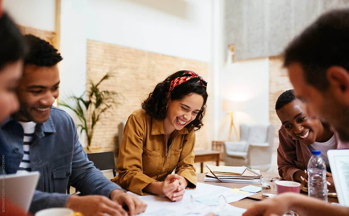 Happy multiracial casually dressed business people working together and having meeting in office
