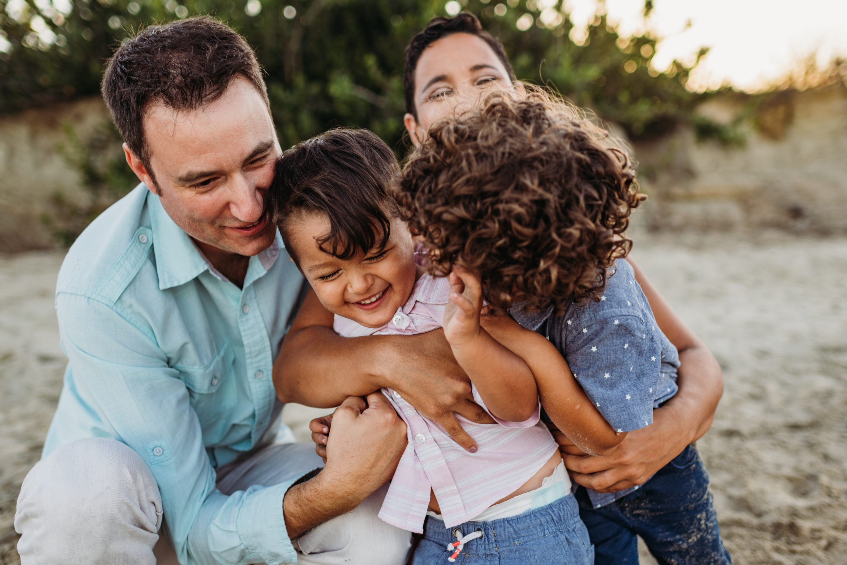 A family with their two children hugging.