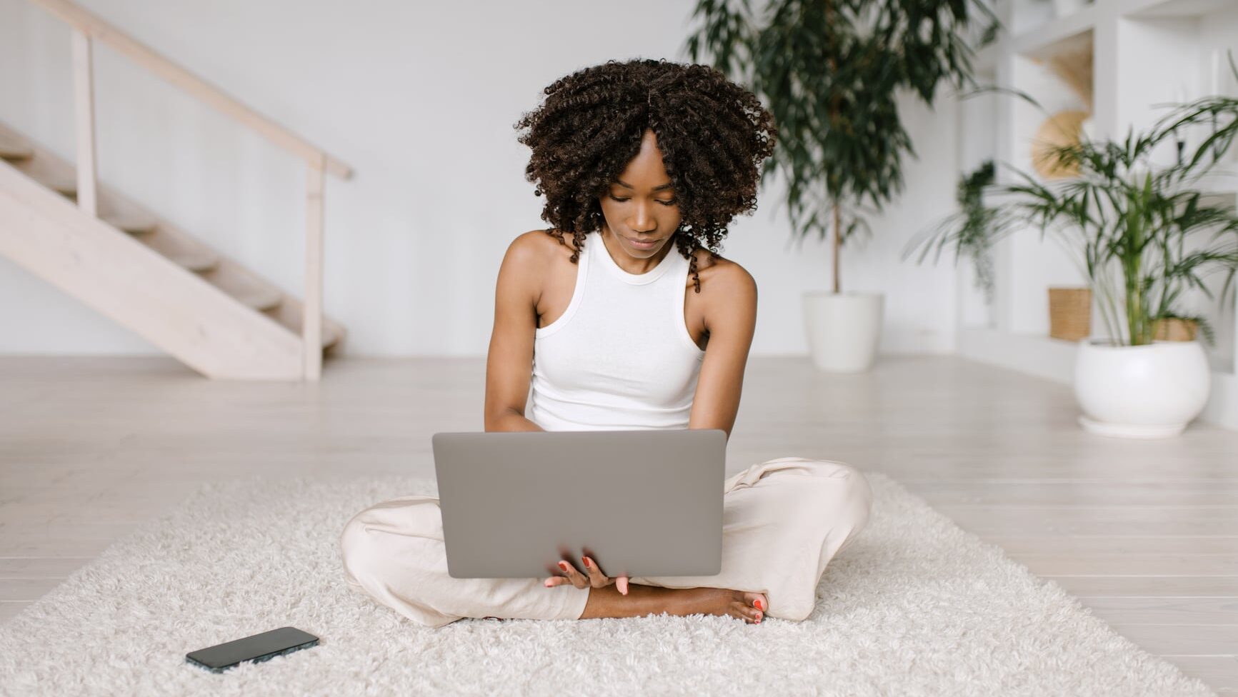 Beautiful busy woman working with laptop at home