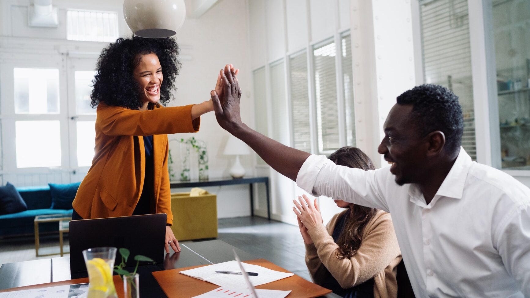 Work colleagues celebrate landing a new business deal