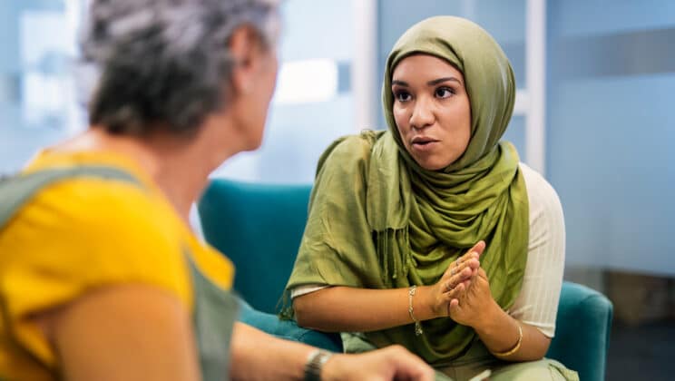 muslim woman in hijab and caucasian senior woman working together in the office