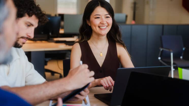 Group of smiling employees are concentrating on a meeting in a modern office space