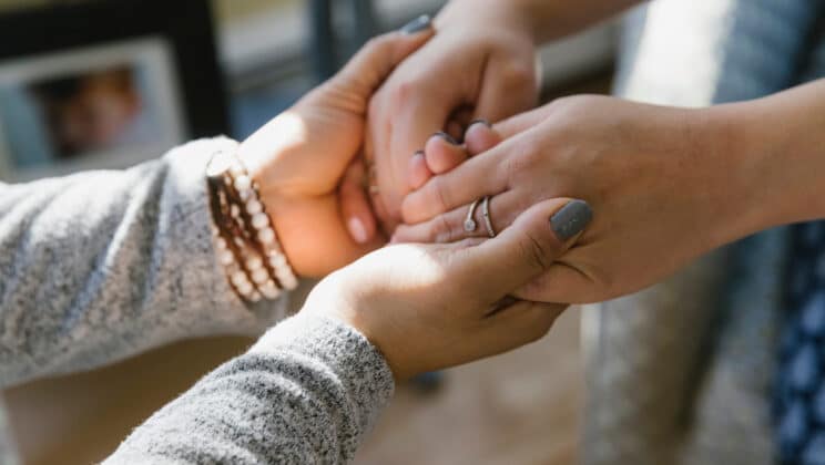 Doula Photography of expectant Pregnant woman meeting with her Doula and holding Hands