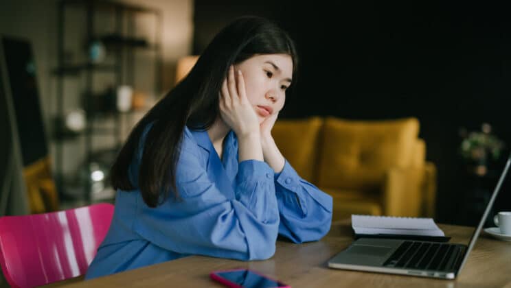 Asian Woman Working On Laptop From Home