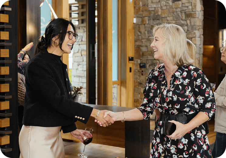 two women shaking hands