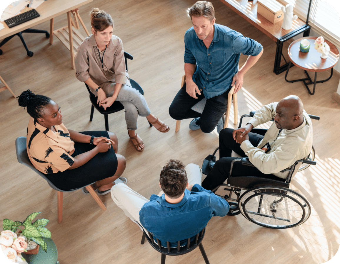 group of five people in a circle talking