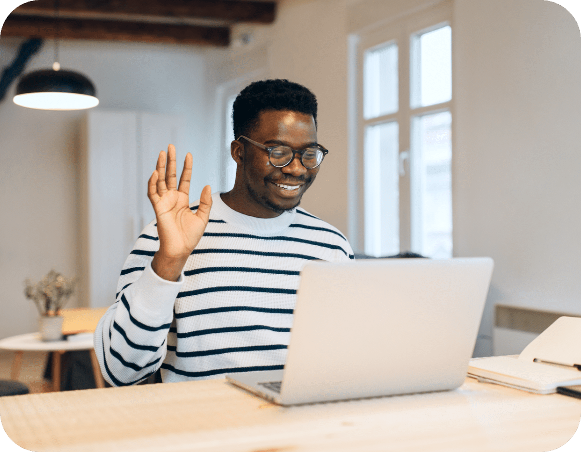 man waving hi to his laptop