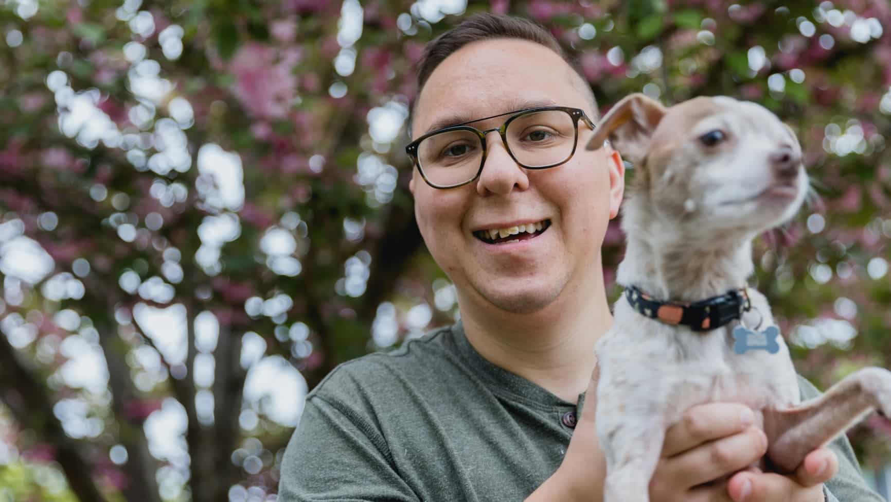 man holding a dog in his hands