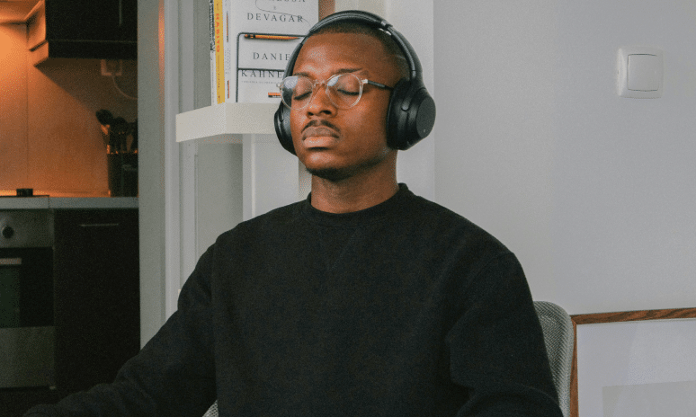 man with headphones on closing his eyes