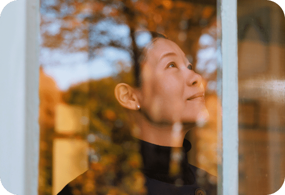 woman staring out the window
