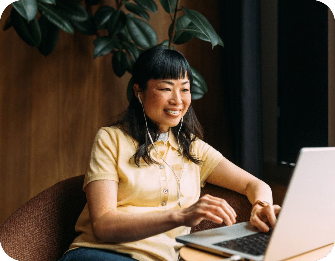 woman on her laptop with headphones in