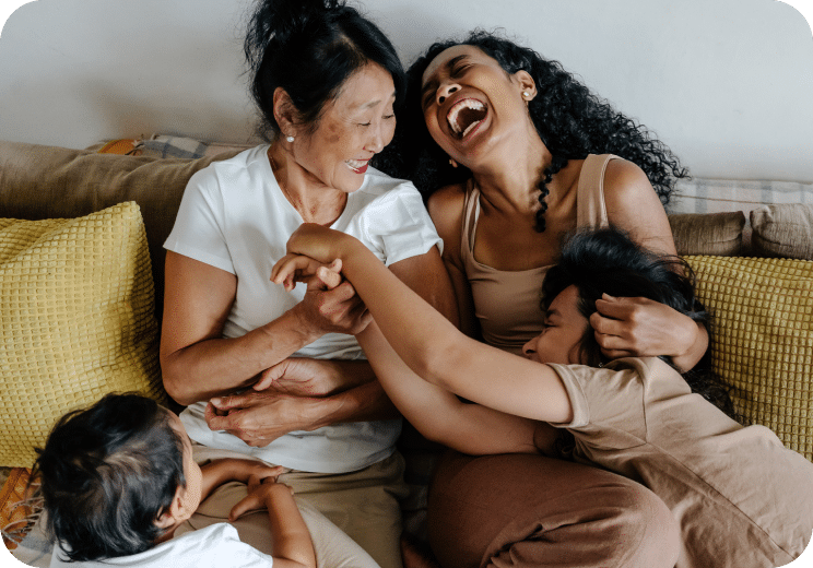 two women and two children laughing together