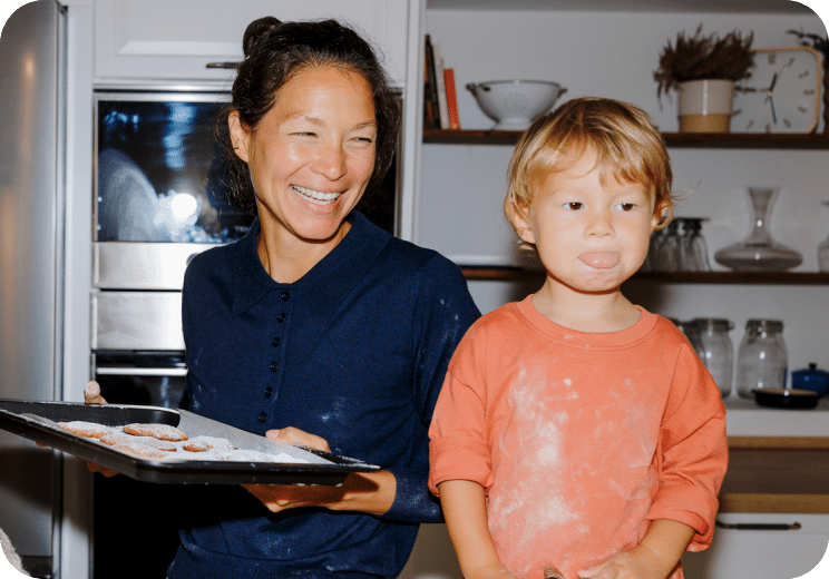 a woman smiling at a child
