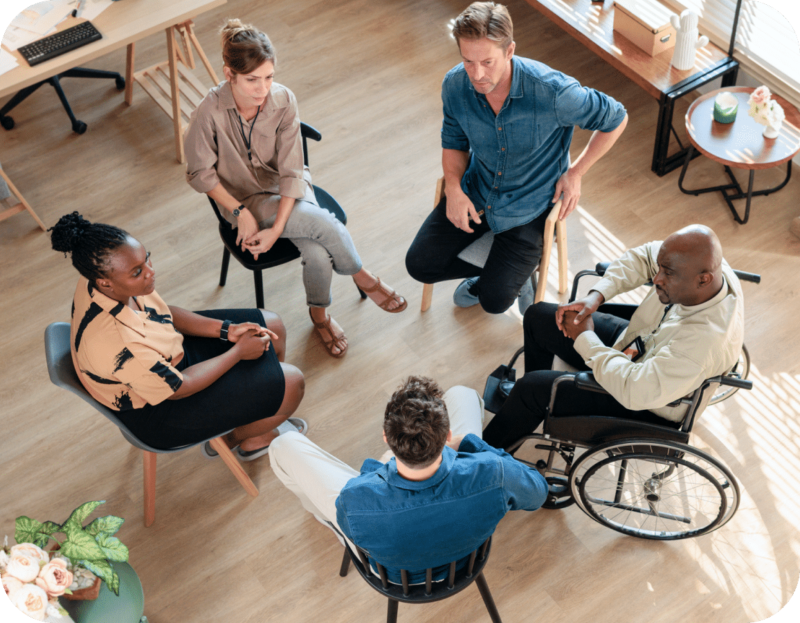 Diverse group of five adults speaking in a circle