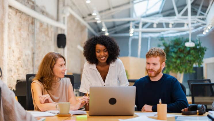 Diverse coworkers in a meeting discussing about innovative strategy for a successful business plan in modern co-working space.