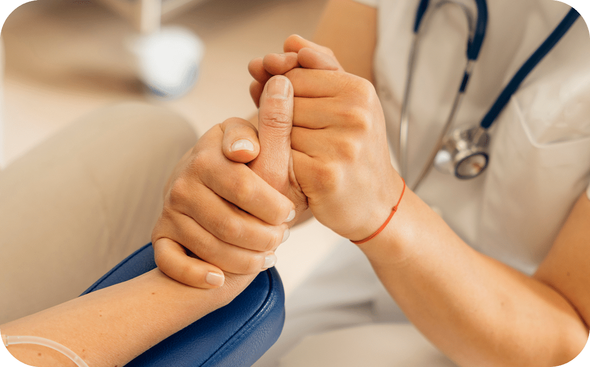 Doctor holding a patients hand