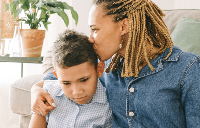 mother kissing son on head